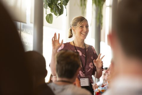 brand photography - A woman is presenting at a networking meeting, highlighting how can help you stand out and showcase the character of your people and business