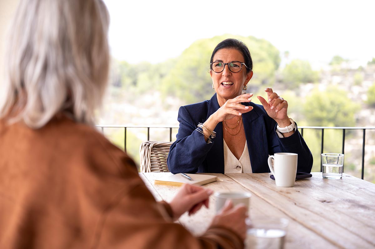 Authentic brand photography showing a professional strategy consultation between two women. The image illustrates the power of human connection in business storytelling